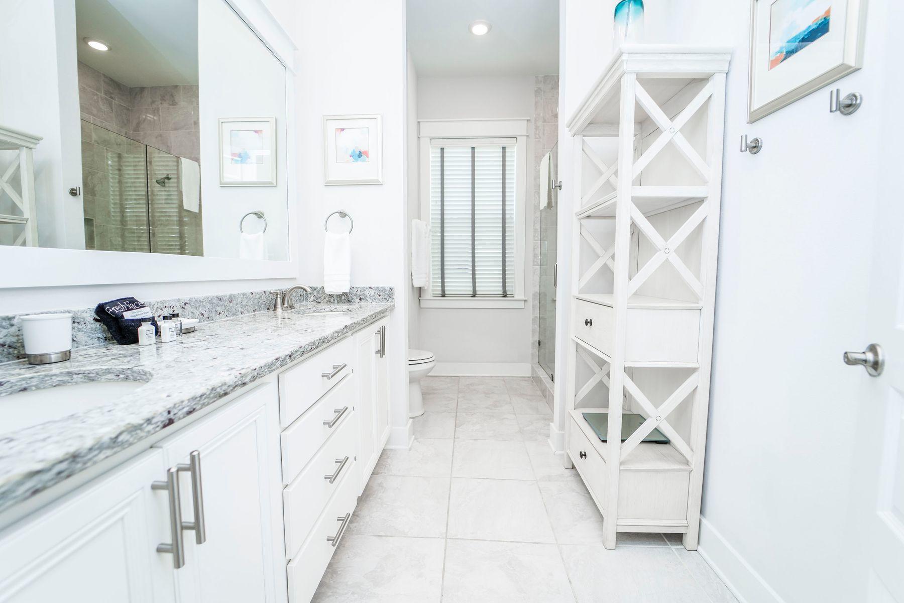 58 York Ln Inlet Beach, Unit B Inlet Beach, FL 32461 - Photo 11 of 24 a spacious bathroom with a granite countertop sink and a mirror