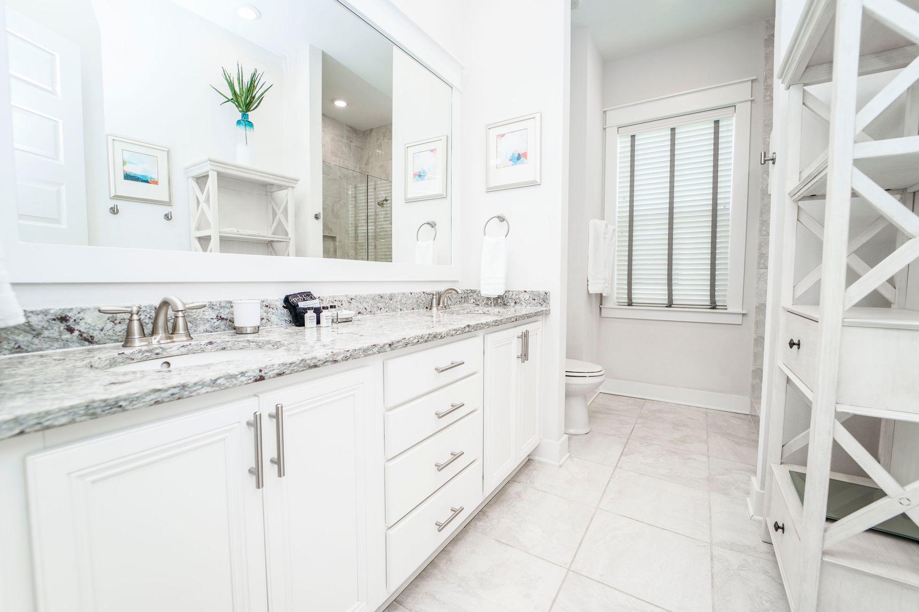58 York Ln Inlet Beach, Unit B Inlet Beach, FL 32461 - Photo 12 of 24 a bathroom with a granite countertop sink and a mirror