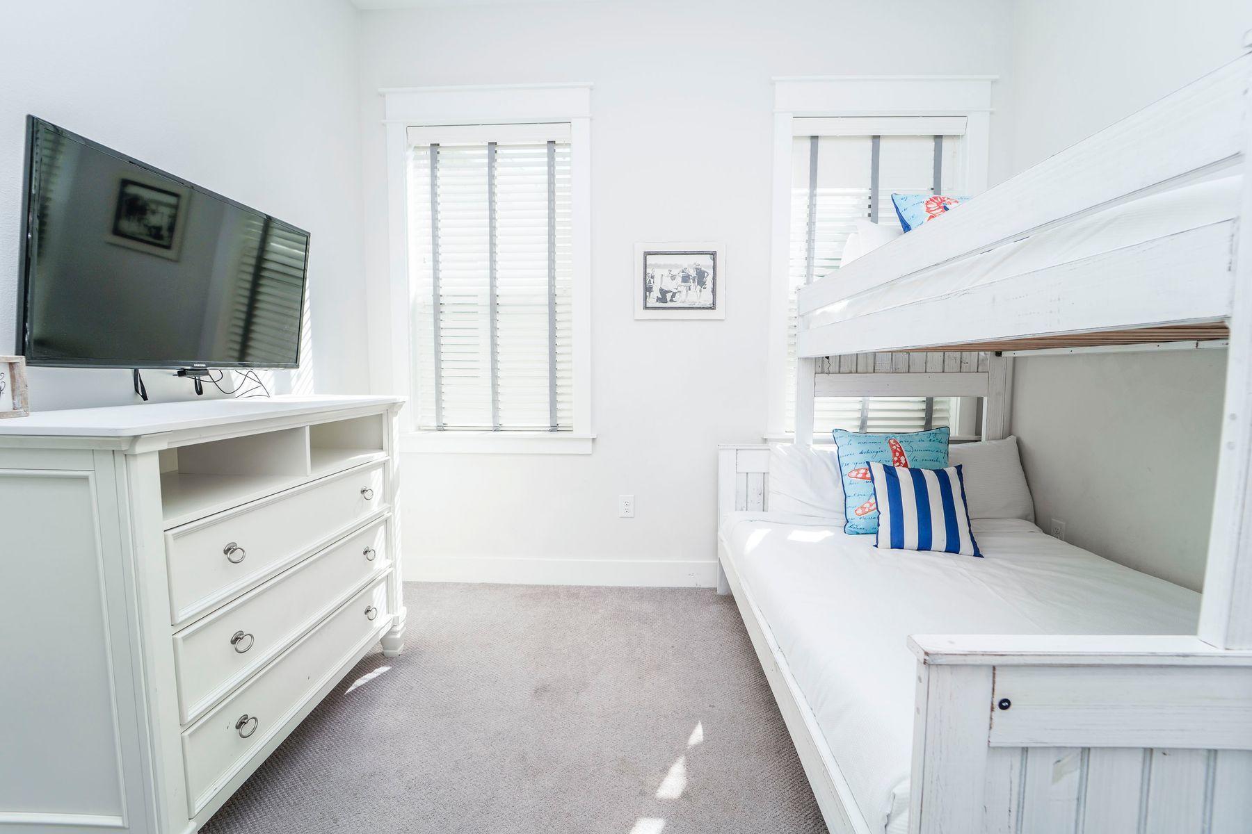 58 York Ln Inlet Beach, Unit B Inlet Beach, FL 32461 - Photo 14 of 24 a room with a bed and a flat screen tv