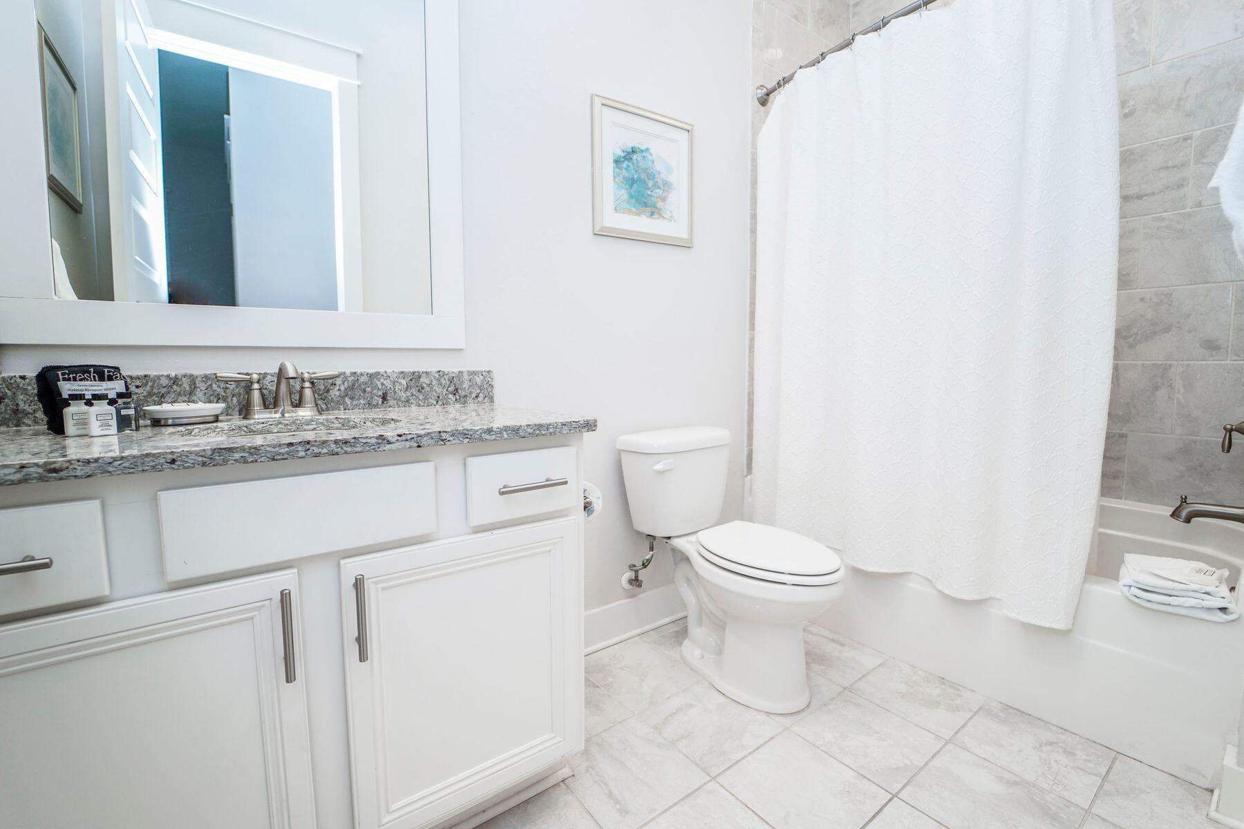 58 York Ln Inlet Beach, Unit B Inlet Beach, FL 32461 - Photo 16 of 24 a bathroom with a toilet sink vanity and mirror
