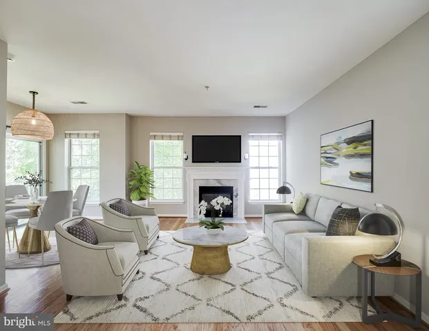 a living room with fireplace furniture and a fireplace