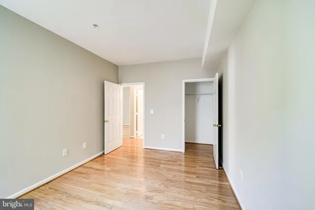 a view of an empty room with wooden floor