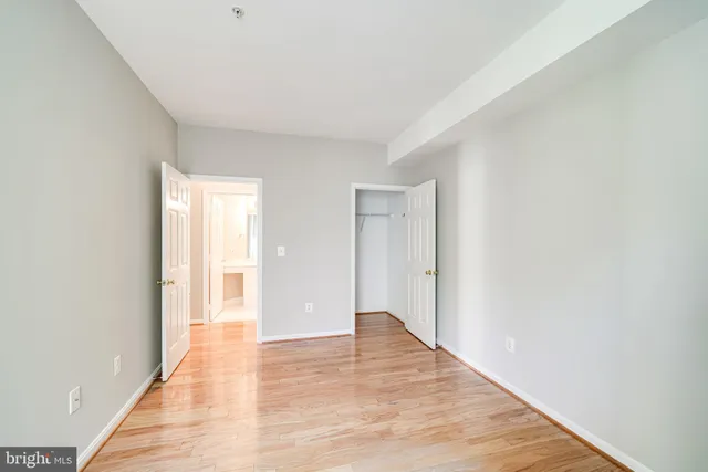 a view of an empty room with wooden floor