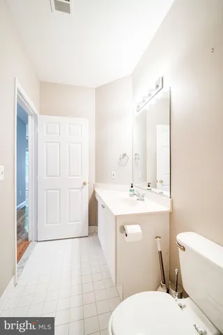 a bathroom with a sink a toilet and mirror