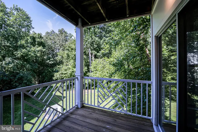 a view of a balcony with wooden floor