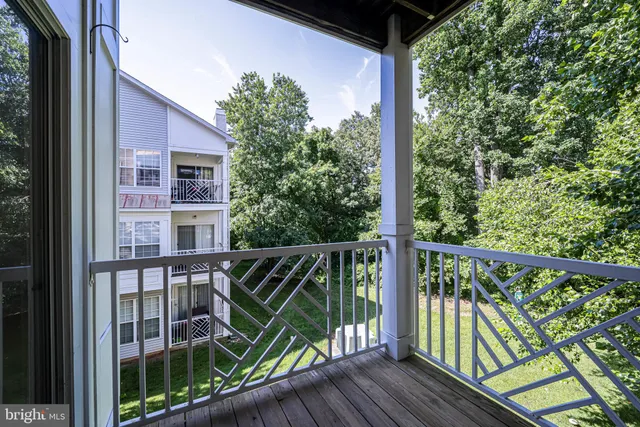 a view of balcony with floor to ceiling window and wooden fence