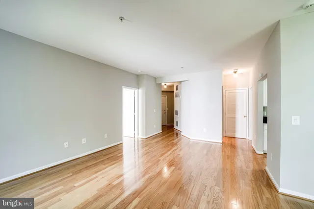 a view of an empty room and wooden floor