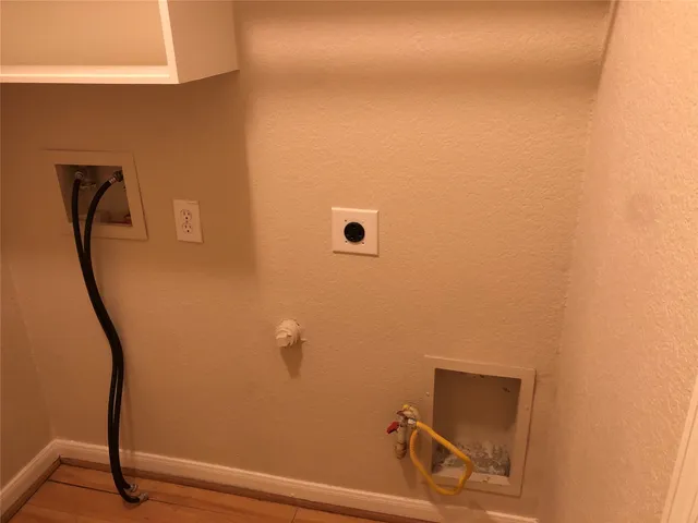 a room with a wooden floor and white walls