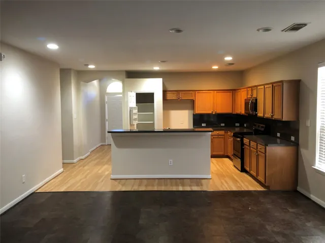 a view of kitchen with refrigerator and microwave