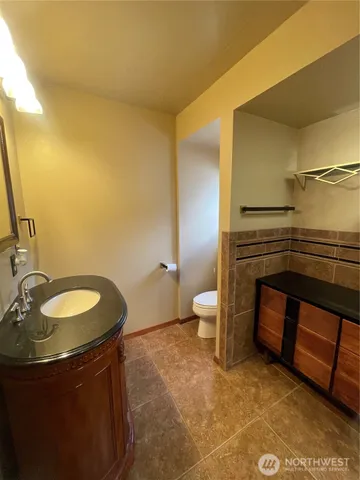 a bathroom with a sink a toilet and a mirror