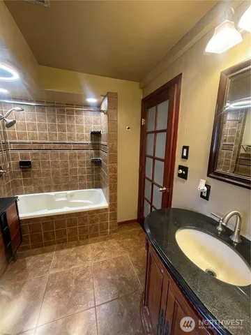 a bathroom with a granite countertop sink and mirror