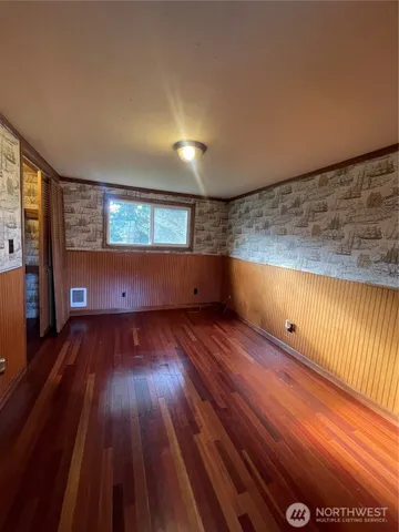 a view of wooden floor and windows in a room