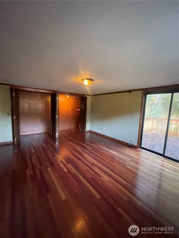 a view of a room with wooden floor