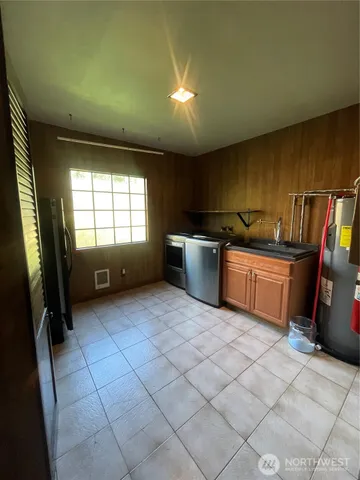 a kitchen with stainless steel appliances a stove a sink and a refrigerator