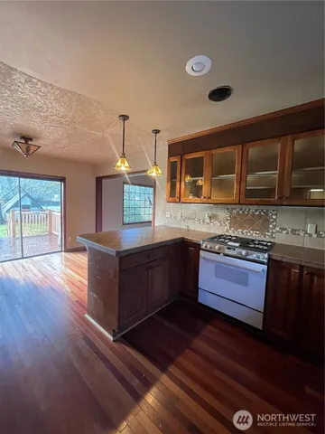 a kitchen with granite countertop wooden cabinets a sink and dishwasher