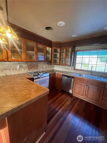 a kitchen with stainless steel appliances granite countertop a stove and a sink