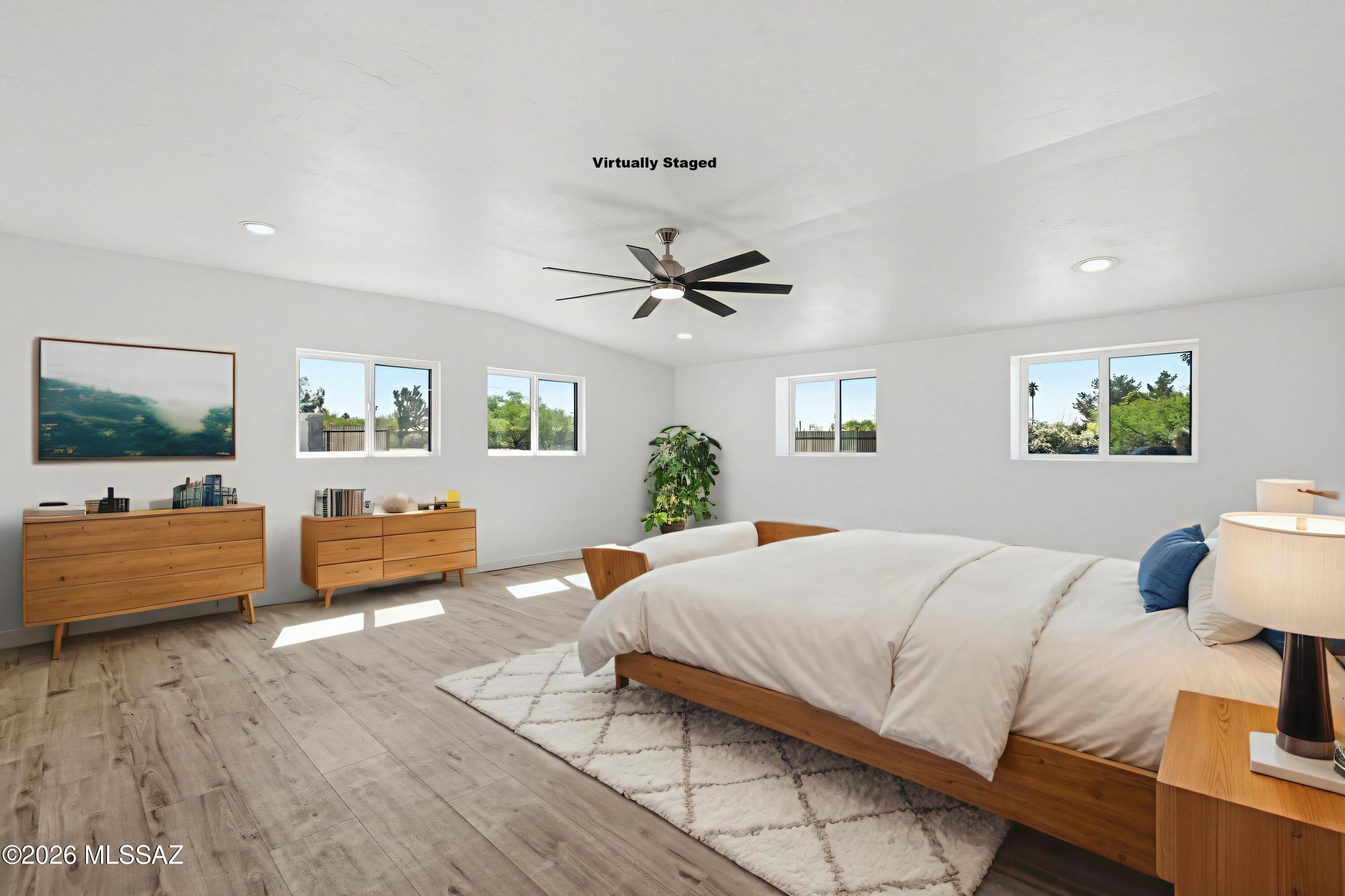 950 West Ina Road Tucson, AZ 85704 - Photo 16 of 54 a bedroom with a bed and wooden floor