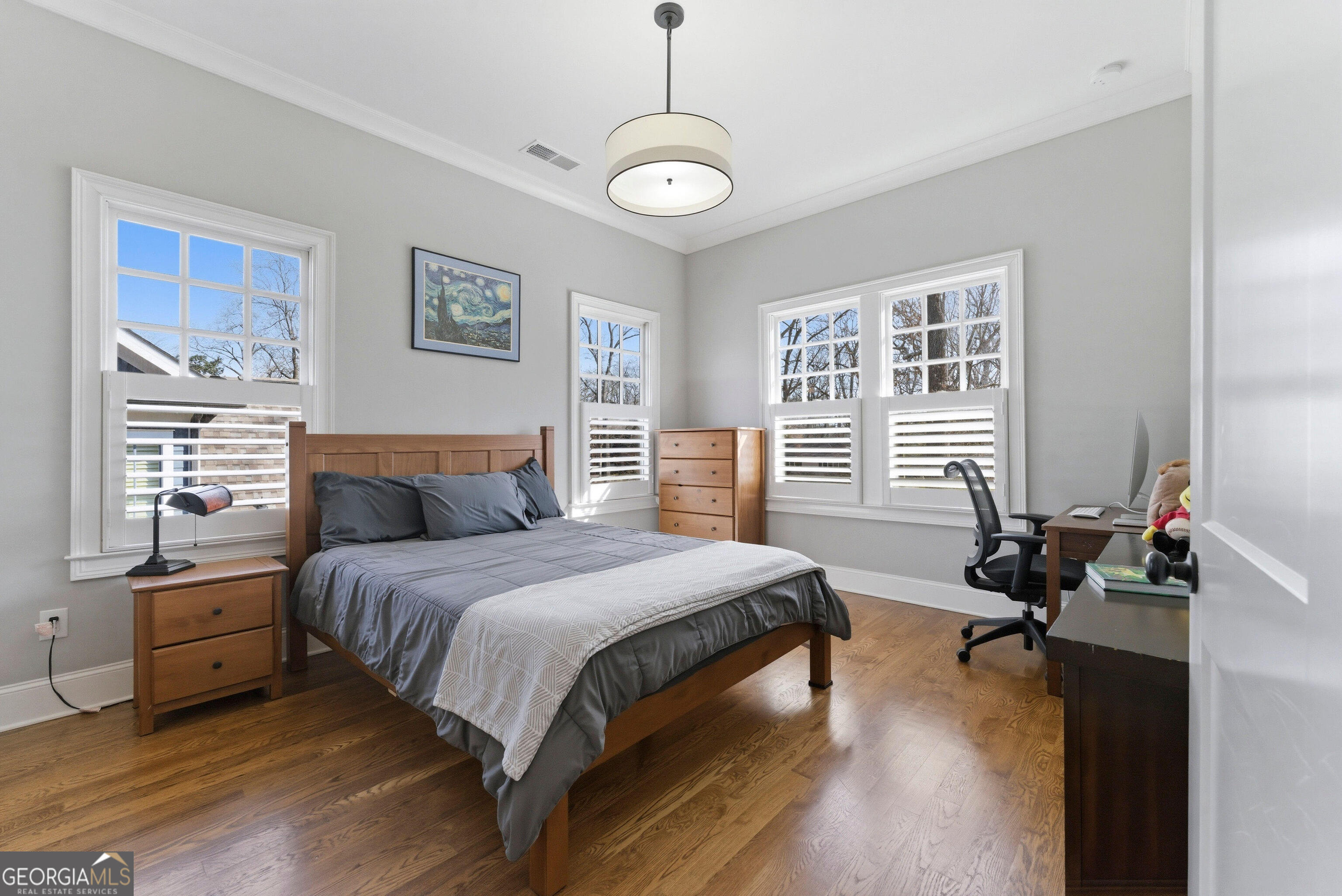1205 Oldfield Road Decatur, GA 30030 - Photo 15 of 37 a bedroom with a bed and a chandelier