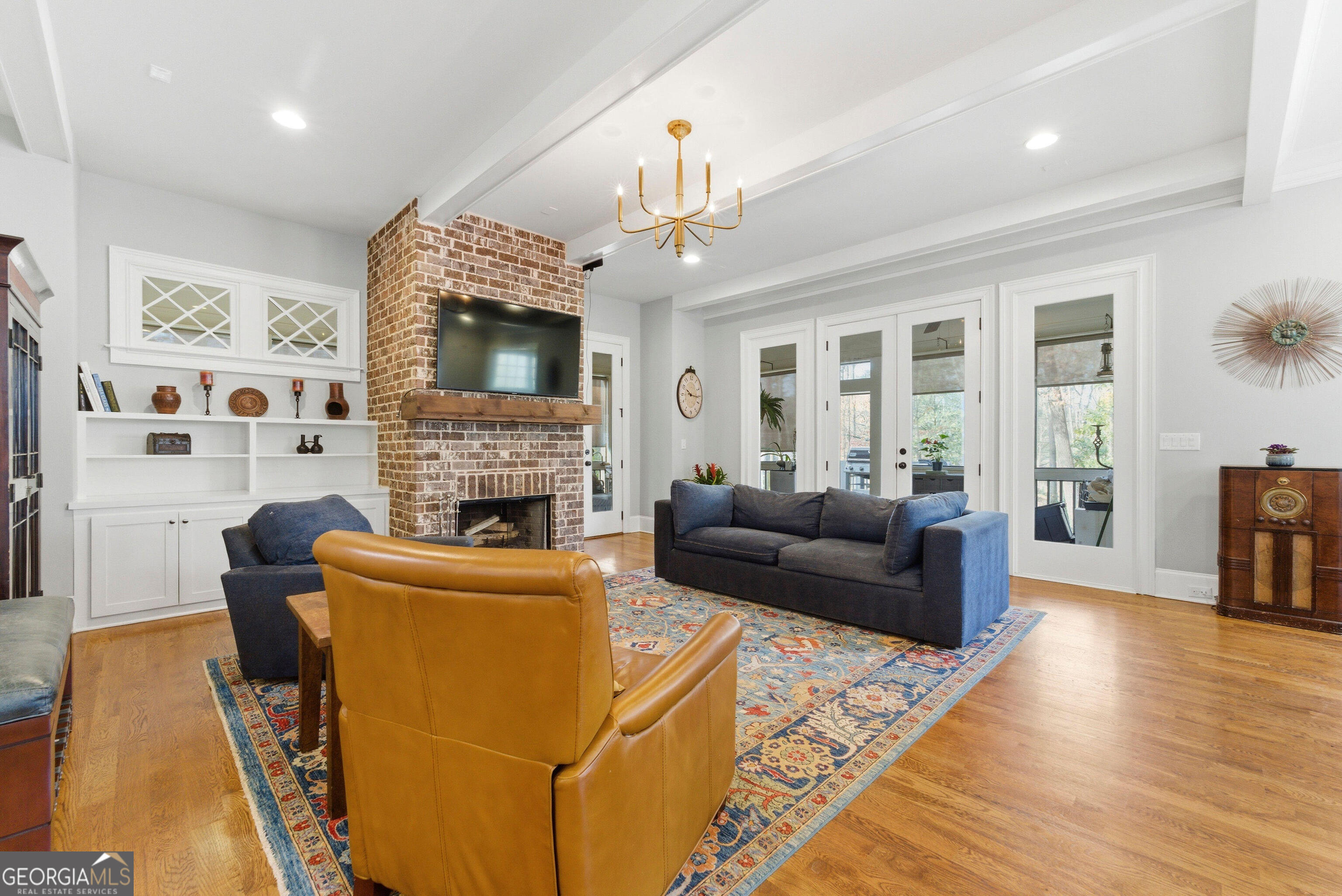 1205 Oldfield Road Decatur, GA 30030 - Photo 5 of 37 a living room with furniture a flat screen tv and a fireplace