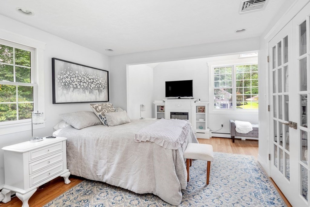 155 Whiting Street Hingham, MA 02043 - Photo 11 of 30 a bedroom with a bed couch and a window