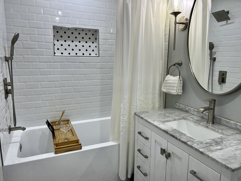 155 Whiting Street Hingham, MA 02043 - Photo 18 of 30 a bathroom with a granite countertop sink and a mirror