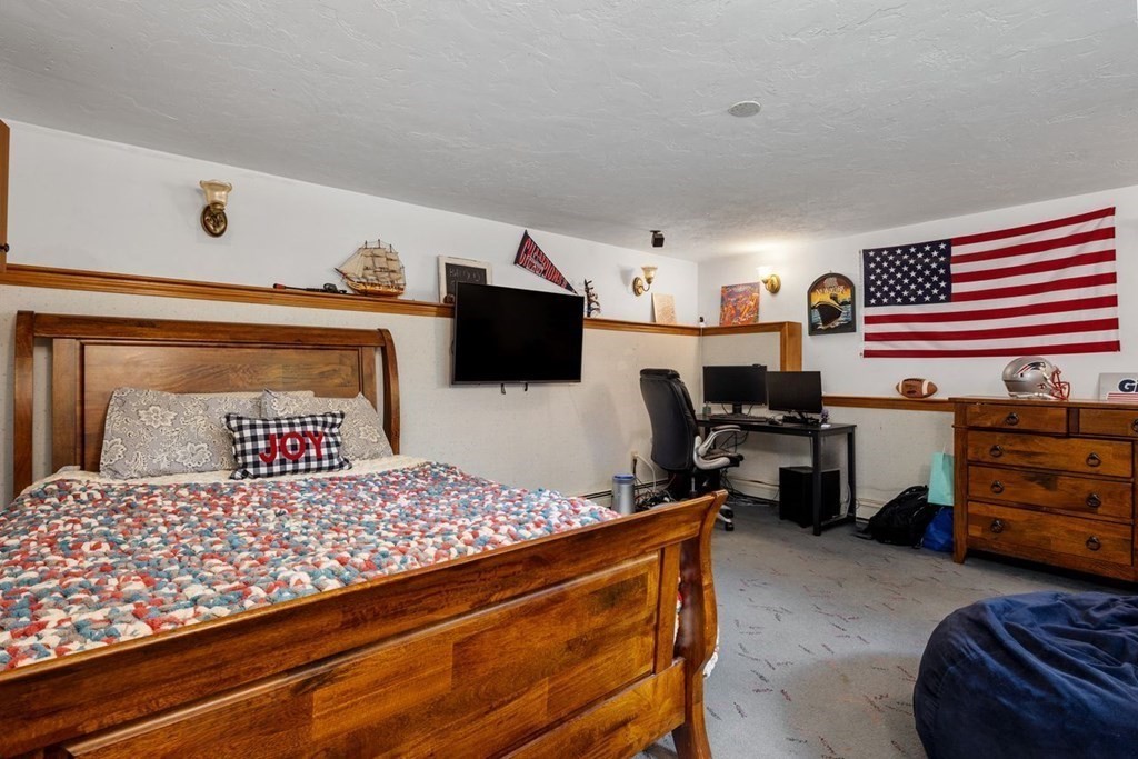 155 Whiting Street Hingham, MA 02043 - Photo 22 of 30 a bedroom with a bed and a television