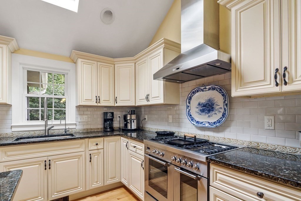 155 Whiting Street Hingham, MA 02043 - Photo 4 of 30 a kitchen with granite countertop a stove and a sink