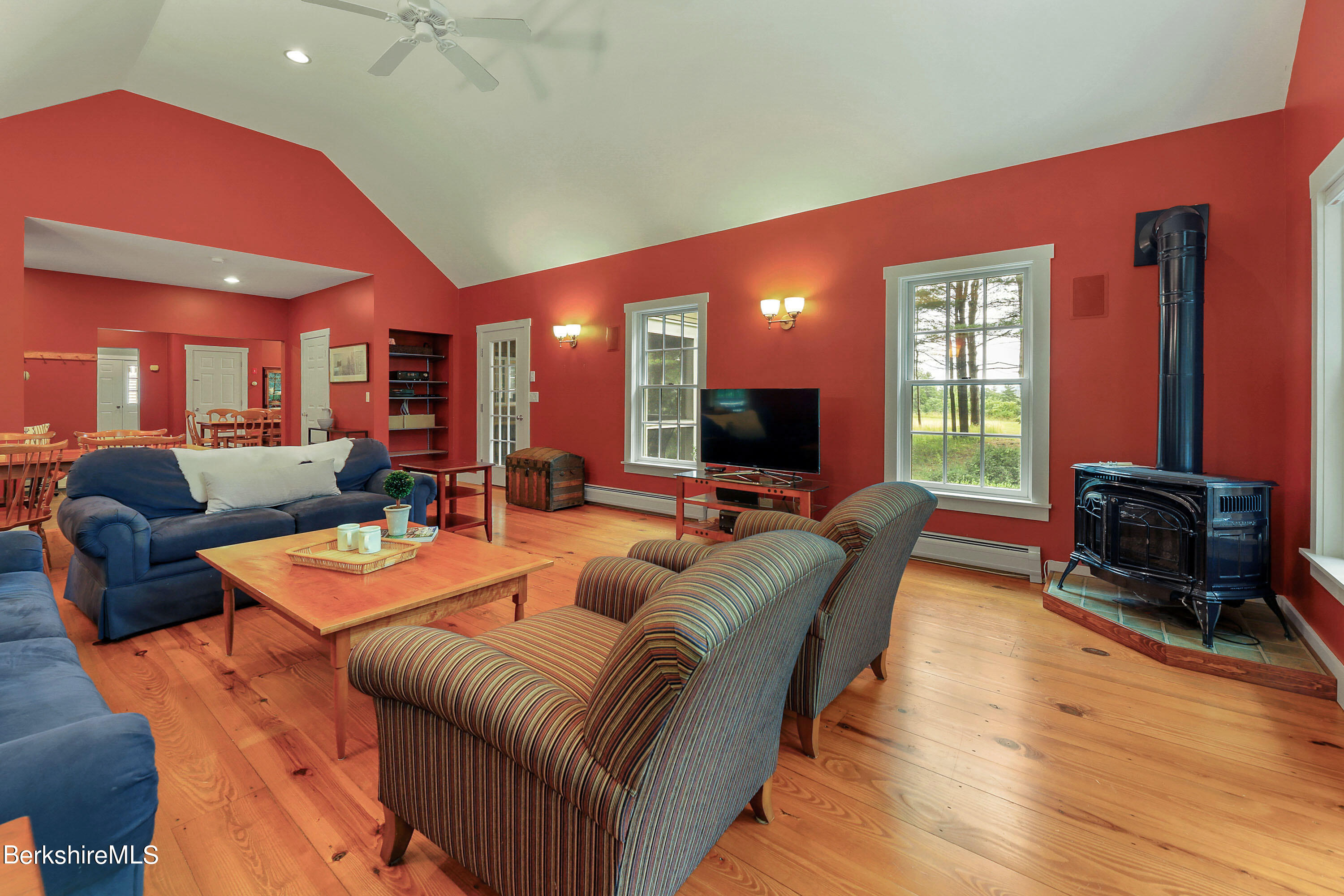 12 Castle Hill Road Stockbridge, MA 01262 - Photo 11 of 39 a living room with furniture a large window and a flat screen tv