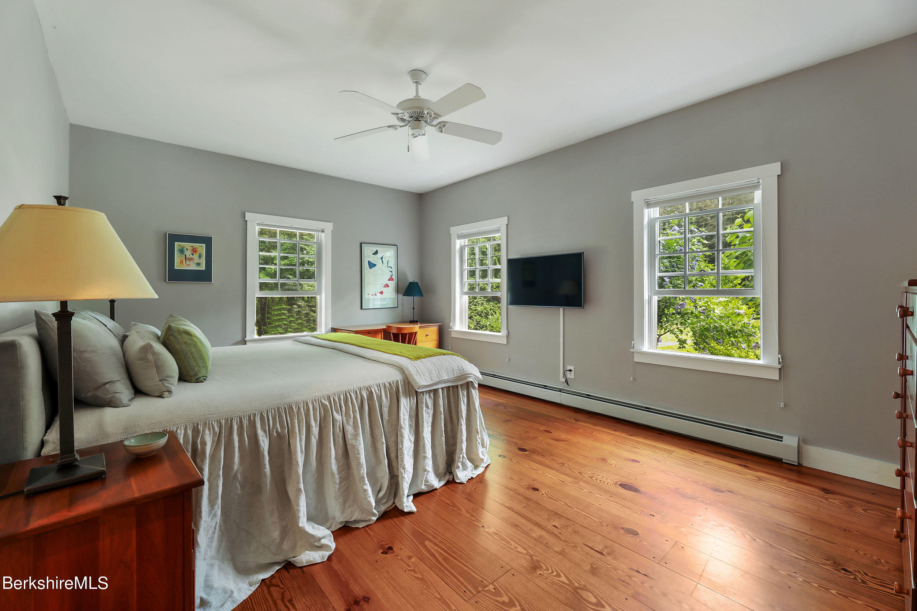 12 Castle Hill Road Stockbridge, MA 01262 - Photo 15 of 39 a bedroom with a large bed and a flat tv screen on dresser