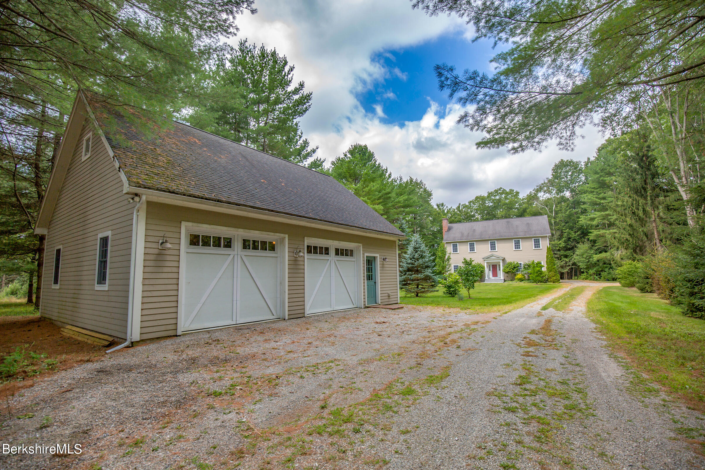 12 Castle Hill Road Stockbridge, MA 01262 - Photo 34 of 39 a front view of a house with a yard and garage