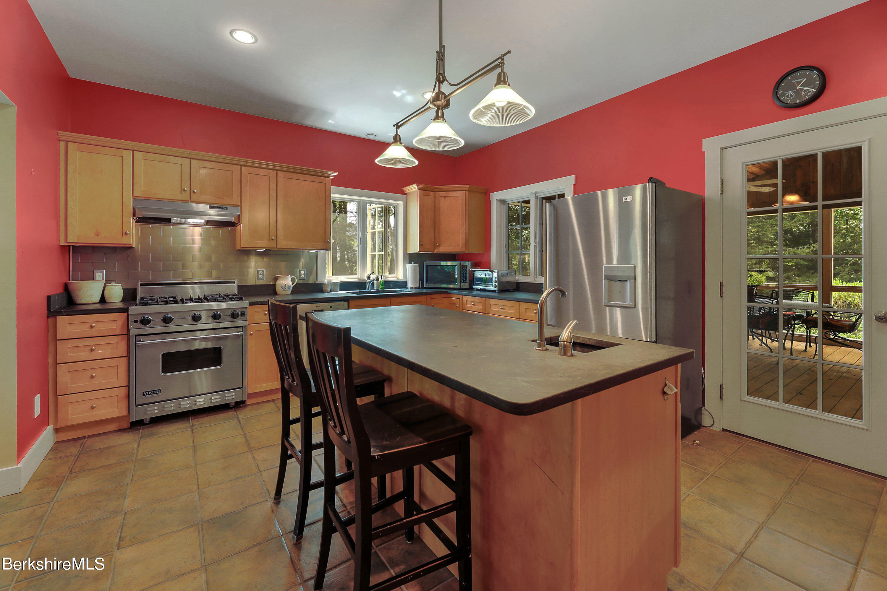 12 Castle Hill Road Stockbridge, MA 01262 - Photo 5 of 39 a kitchen with stainless steel appliances kitchen island granite countertop a table chairs stove and refrigerator