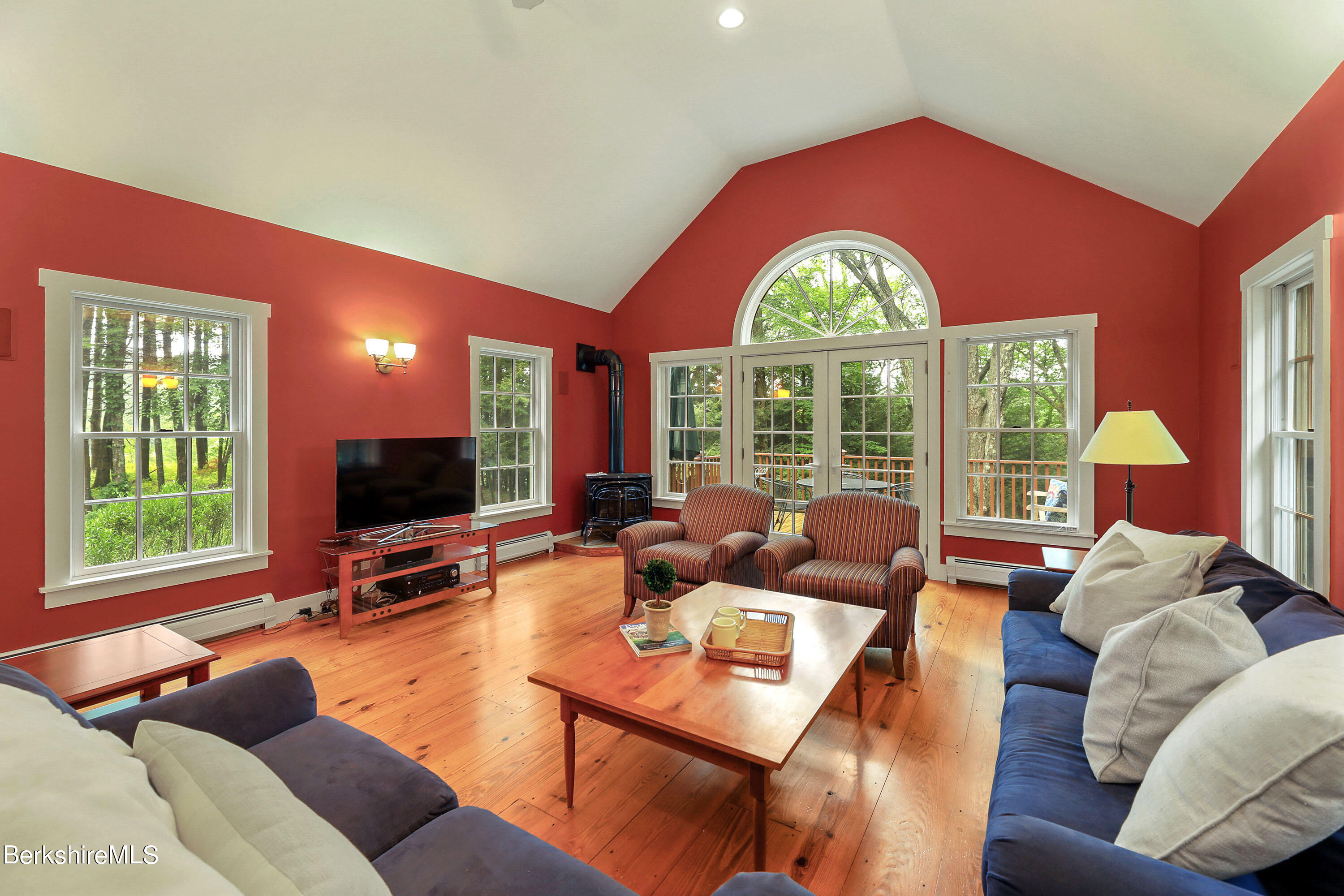 12 Castle Hill Road Stockbridge, MA 01262 - Photo 10 of 39 a living room with furniture a large window and a flat screen tv