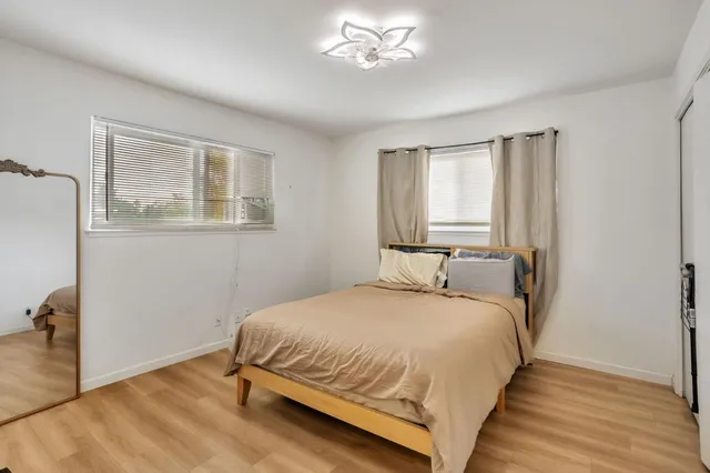 a view of staircase with wooden floor and white walls