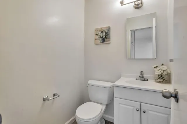 a bathroom with a sink a toilet and mirror