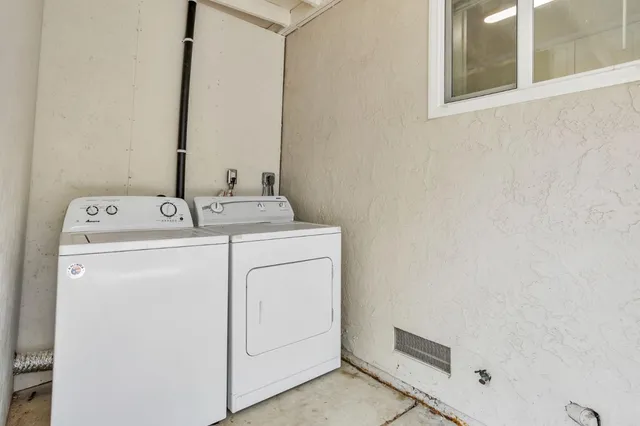 a view of a house with wooden fence