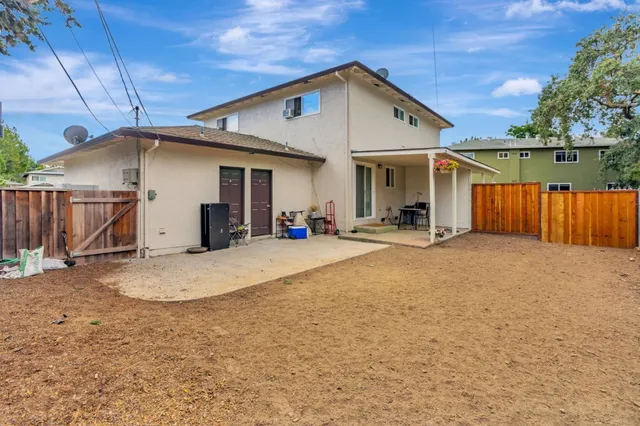 a view of a porch with chairs and a yard