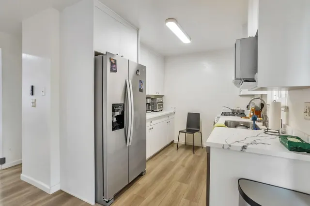 a kitchen with a sink and wooden cabinets