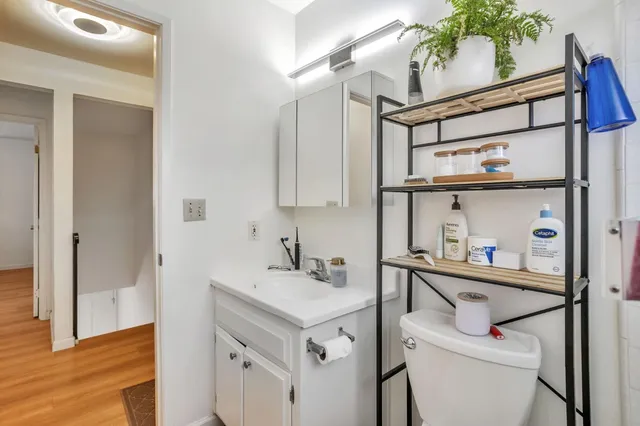 a bathroom with a sink a toilet and mirror