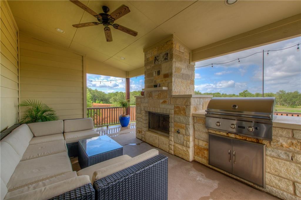 1511 Rimstone Drive Cedar Park, TX 78613 - Photo 32 of 39 An inviting outdoor living space features a stone fireplace and built-in barbecue.