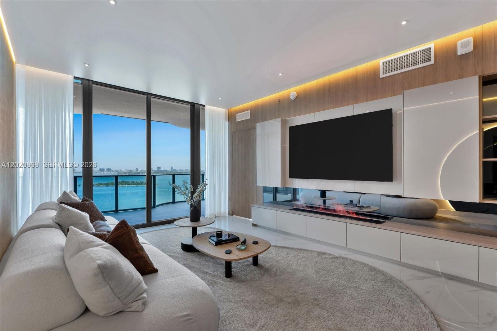 700 Northeast 24th Street, Unit 1602 Miami, FL 33137 - Photo 5 of 30 a living room with furniture and a flat screen tv