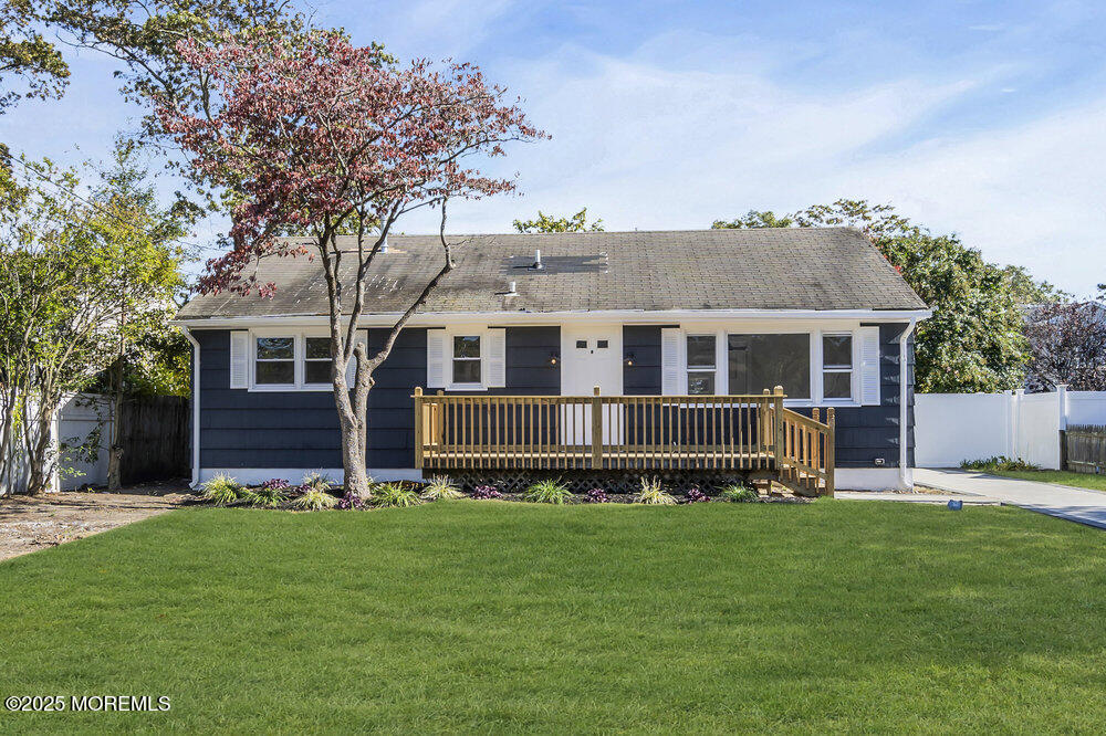 a front view of house with yard and green space