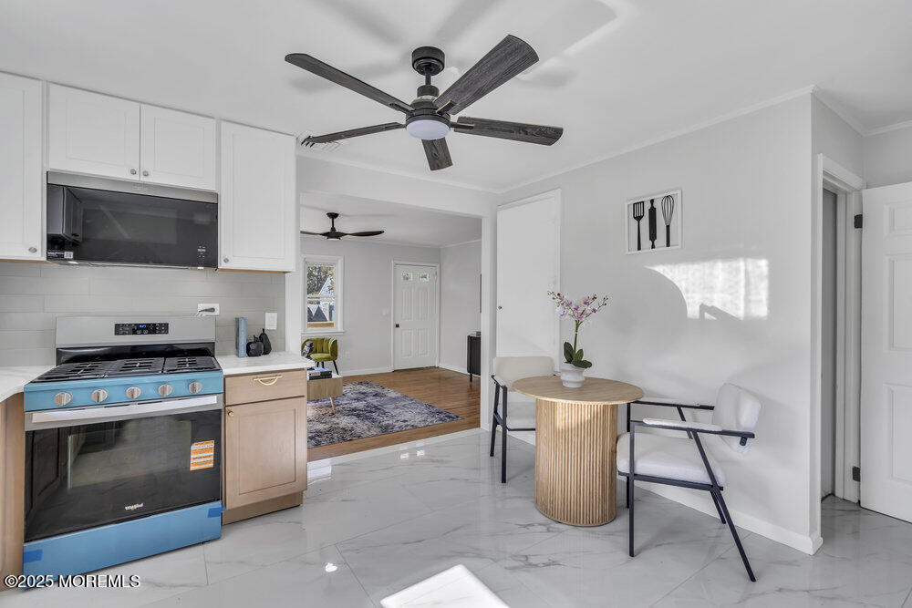 1202 Sunset Avenue Point Pleasant, NJ 08742 - Photo 11 of 23 a kitchen with a stove and a microwave