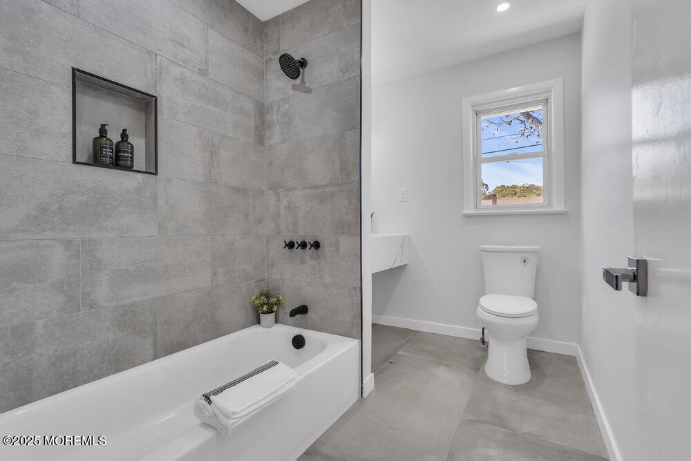 1202 Sunset Avenue Point Pleasant, NJ 08742 - Photo 20 of 23 a bathroom with a toilet a sink and bathtub