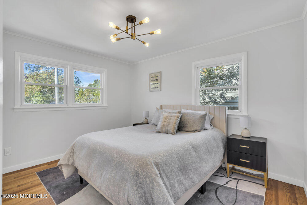 1202 Sunset Avenue Point Pleasant, NJ 08742 - Photo 7 of 23 a bedroom with a bed and wooden floor