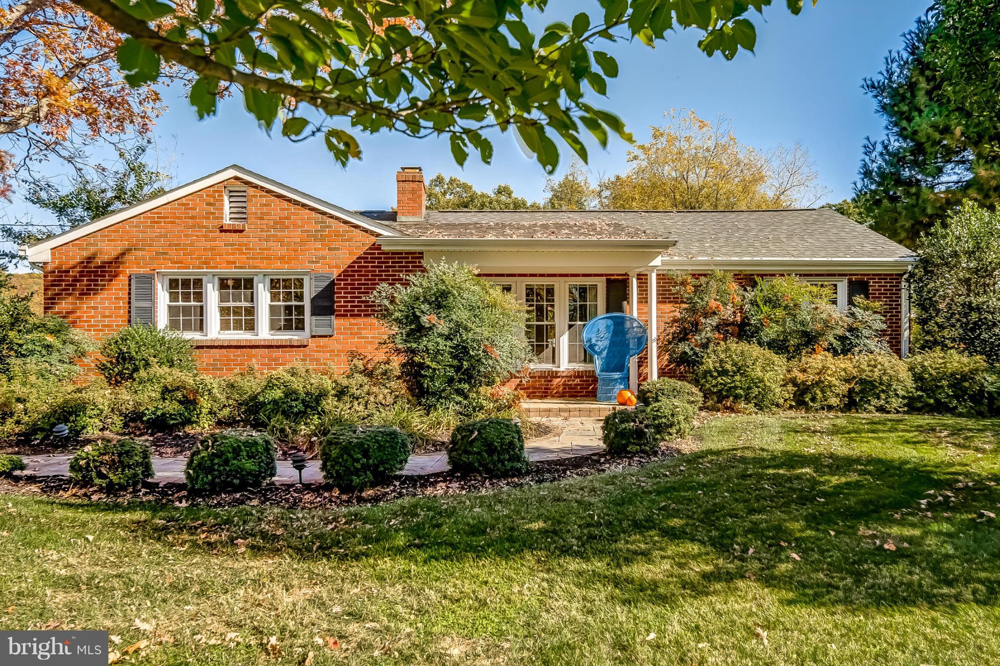 7707 Ridge Road Frederick, MD 21702 - Photo 1 of 30 a view of a house with a yard and potted plants