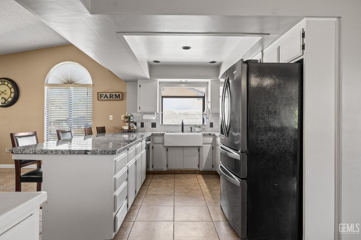 Undisclosed Address Bakersfield, CA 93311 - Photo 17 of 40 a kitchen with a sink refrigerator and cabinets