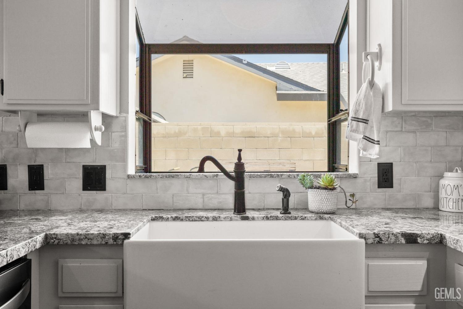 Undisclosed Address Bakersfield, CA 93311 - Photo 19 of 40 a kitchen with granite countertop a sink and a stove