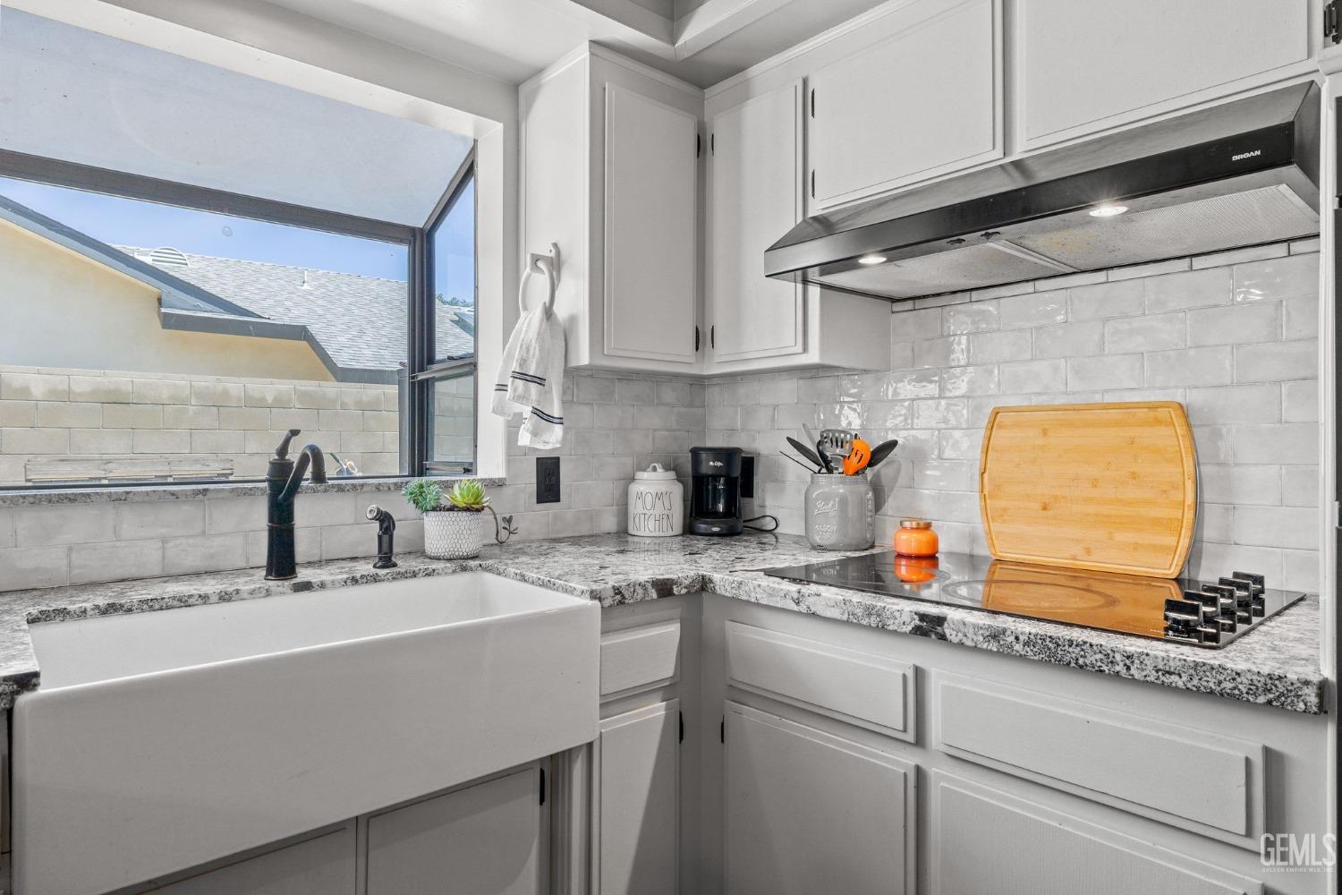 Undisclosed Address Bakersfield, CA 93311 - Photo 20 of 40 a kitchen with stainless steel appliances granite countertop a sink a stove and cabinets