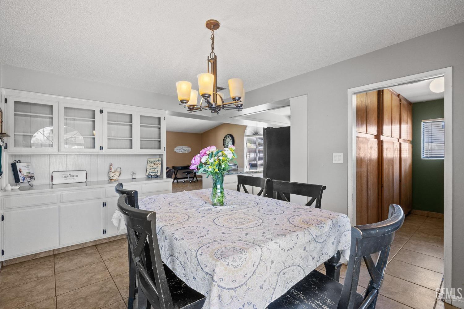 Undisclosed Address Bakersfield, CA 93311 - Photo 23 of 40 a view of a dining room with furniture and chandelier