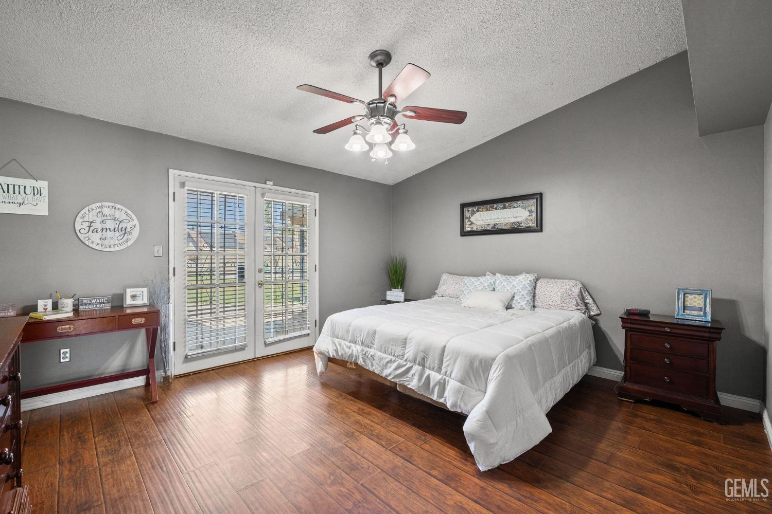 Undisclosed Address Bakersfield, CA 93311 - Photo 26 of 40 a bedroom with a bed and a chandelier